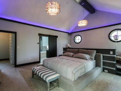 Master Bedroom With Accent Mood Lighting And Elevated Seating Area